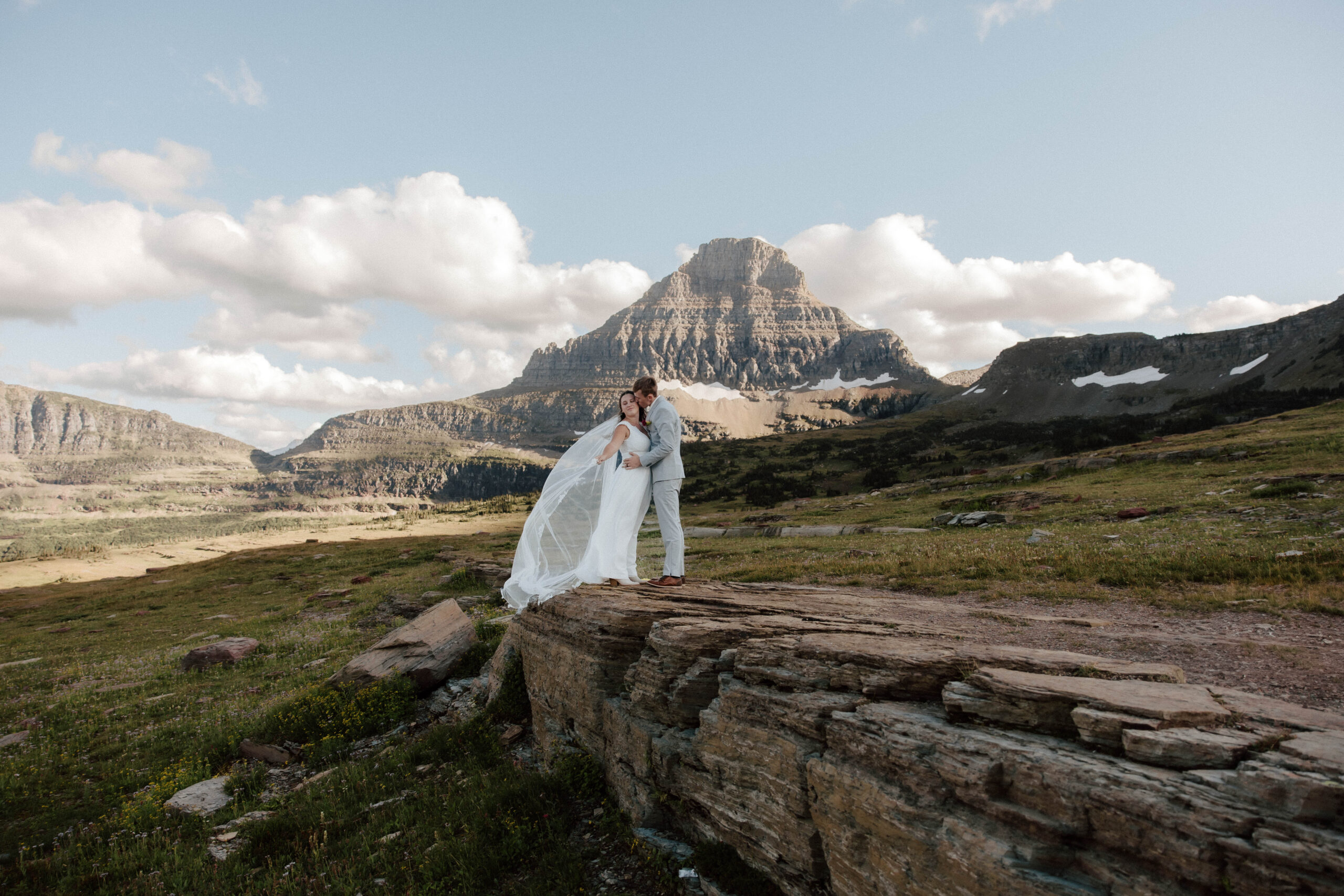 Intimate elopement moment in Glacier National park surrounded by mountain views.